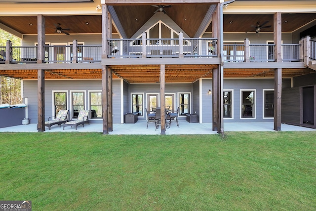 back of house featuring ceiling fan, a patio area, and a lawn