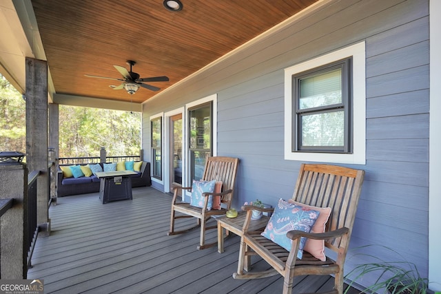 wooden terrace featuring ceiling fan and covered porch