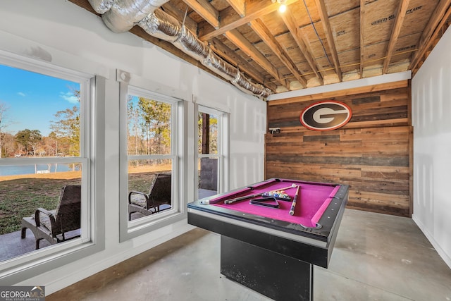 game room featuring concrete flooring, pool table, and wood walls