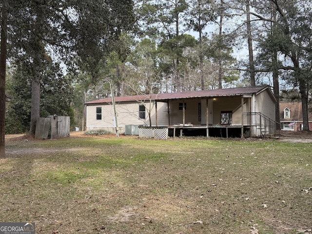 back of house featuring cooling unit and a yard