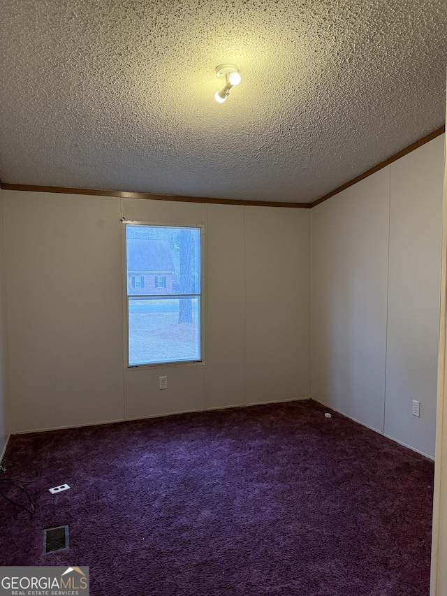 empty room featuring carpet floors, ornamental molding, and a textured ceiling