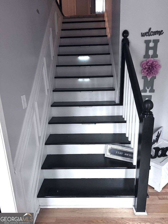 stairway featuring hardwood / wood-style flooring