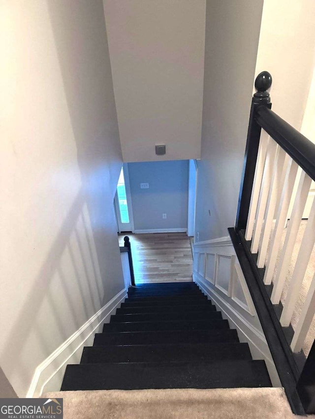 stairs featuring hardwood / wood-style flooring