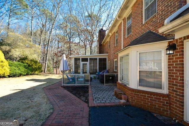 view of patio featuring a sunroom