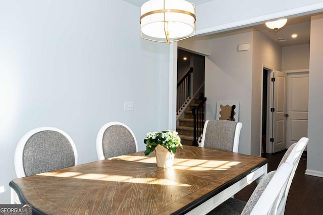 dining area featuring dark wood-type flooring