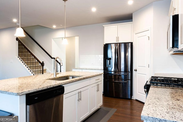 kitchen with pendant lighting, an island with sink, white cabinetry, sink, and stainless steel appliances