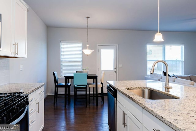 kitchen featuring sink, light stone counters, decorative light fixtures, dishwasher, and white cabinets