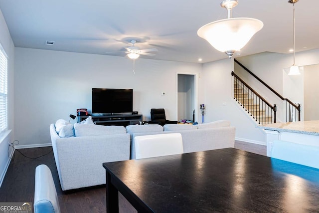 dining space with dark wood-type flooring and ceiling fan