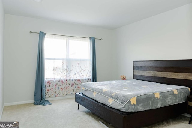 bedroom featuring light colored carpet