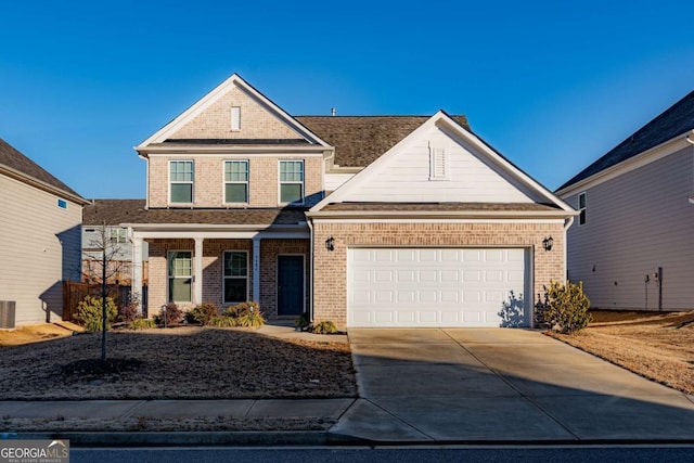 view of front of home featuring central AC unit and a garage