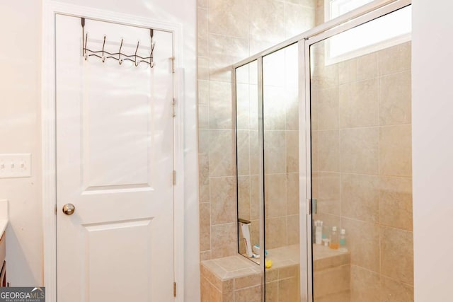 bathroom with an enclosed shower and vanity