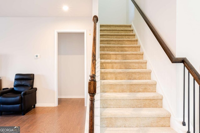 staircase with wood-type flooring