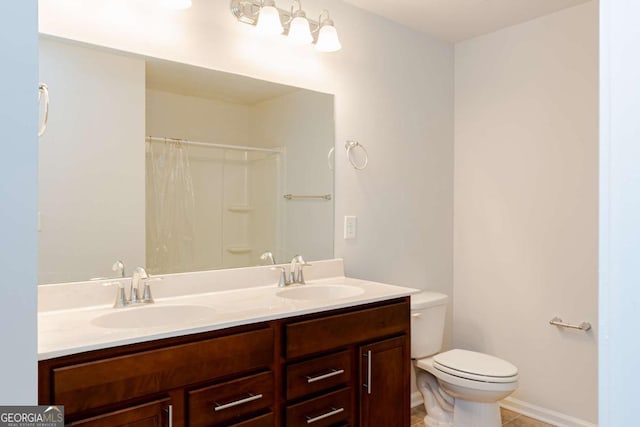 bathroom featuring tile patterned flooring, vanity, walk in shower, and toilet