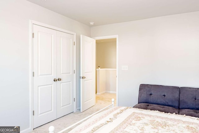 unfurnished bedroom featuring light colored carpet and a closet