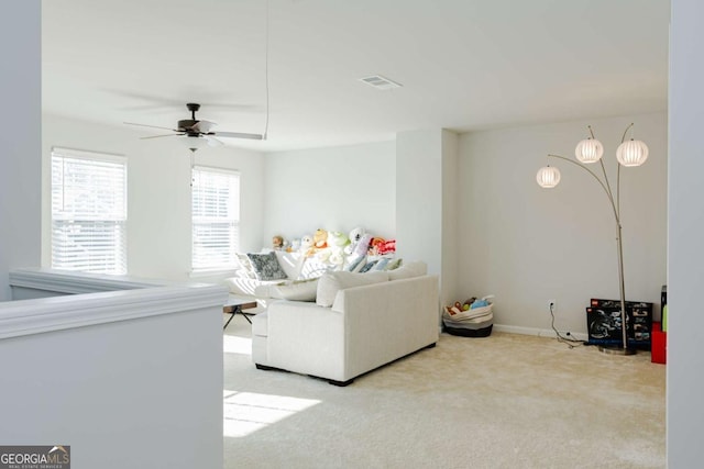 carpeted living room featuring ceiling fan