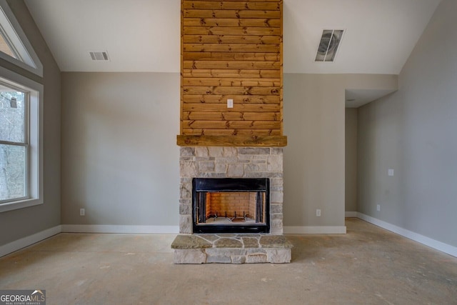 unfurnished living room featuring a healthy amount of sunlight, baseboards, visible vents, lofted ceiling, and a stone fireplace