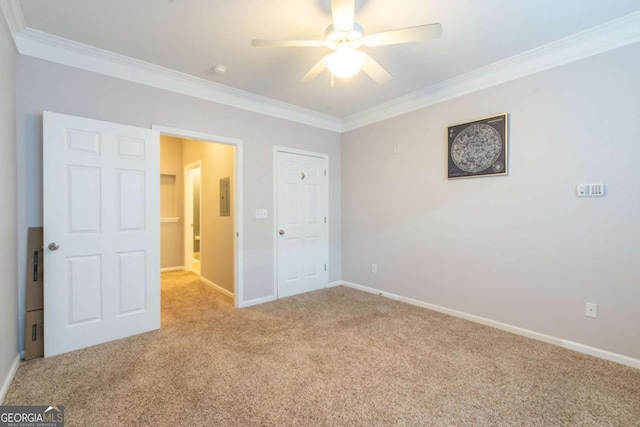 unfurnished bedroom featuring crown molding, light colored carpet, and ceiling fan