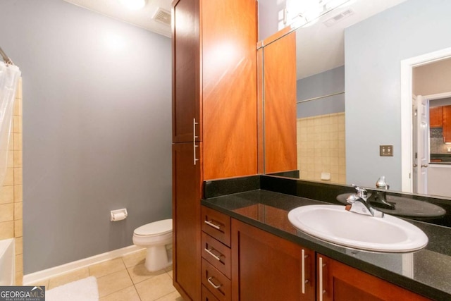 bathroom featuring vanity, tile patterned floors, and toilet