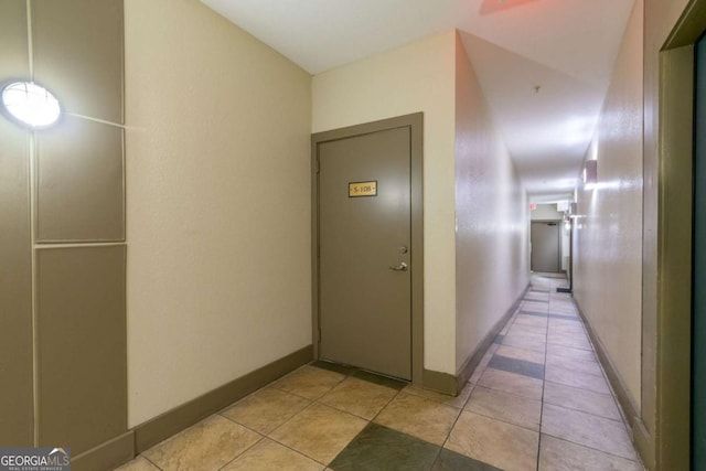 hall with light tile patterned floors