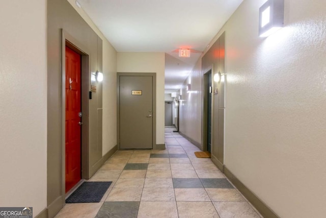 hall with light tile patterned floors