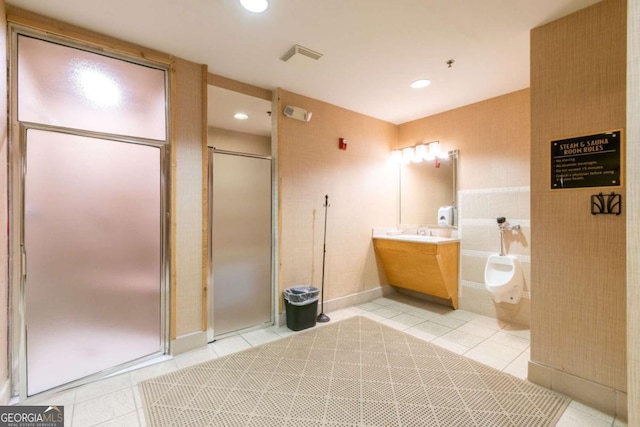 bathroom with walk in shower, tile patterned floors, and vanity