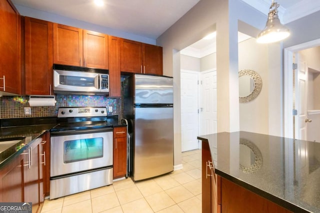 kitchen featuring decorative light fixtures, light tile patterned floors, dark stone counters, stainless steel appliances, and decorative backsplash