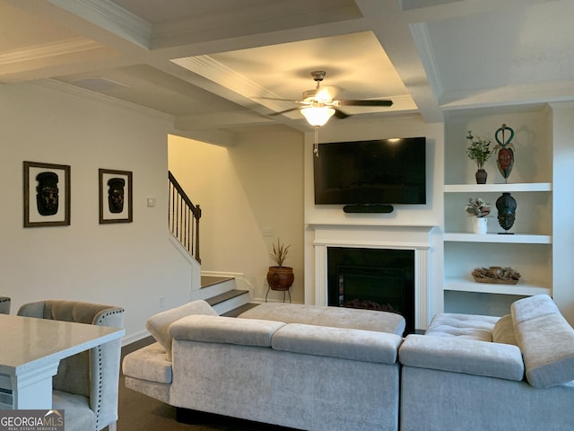 living room featuring ceiling fan, coffered ceiling, beam ceiling, and built in features