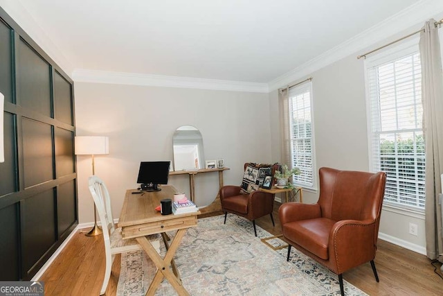 home office with crown molding and light hardwood / wood-style floors