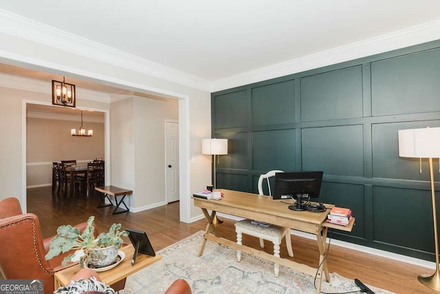 office featuring hardwood / wood-style flooring, ornamental molding, and a notable chandelier