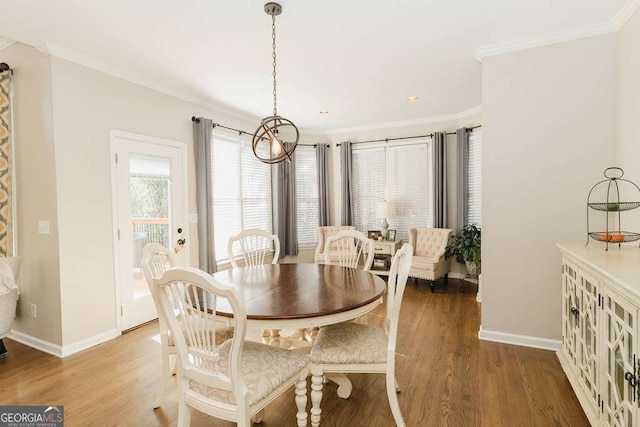 dining area featuring hardwood / wood-style flooring and ornamental molding