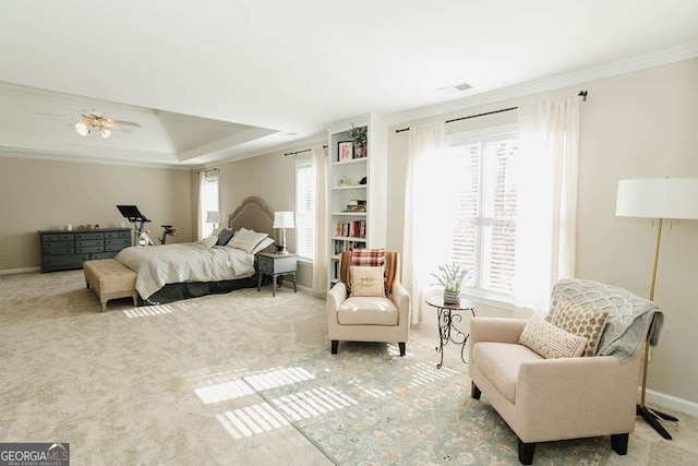 bedroom featuring a tray ceiling, ornamental molding, and light colored carpet