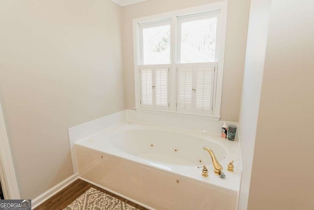 bathroom featuring a tub to relax in and wood-type flooring