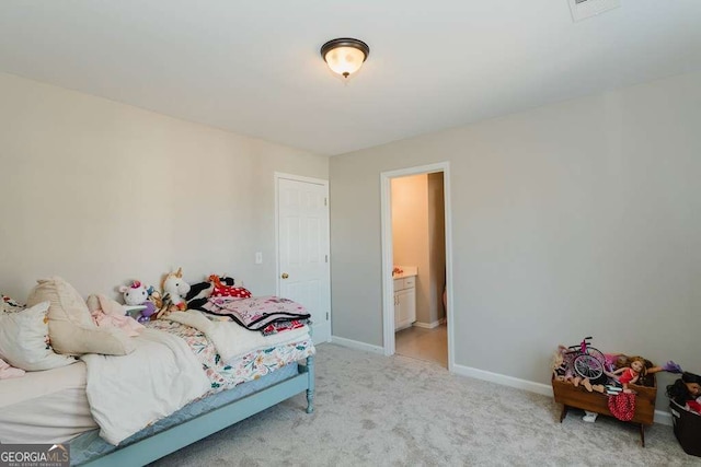 carpeted bedroom featuring connected bathroom