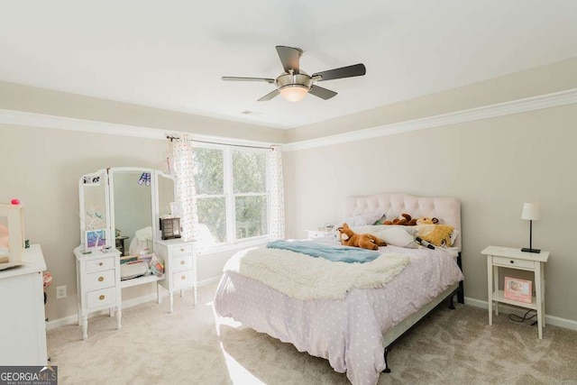 bedroom featuring crown molding, light colored carpet, and ceiling fan