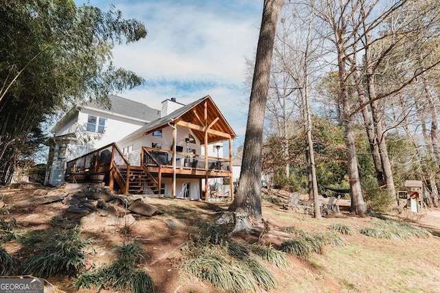 rear view of property featuring a deck