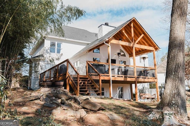 rear view of property featuring a wooden deck