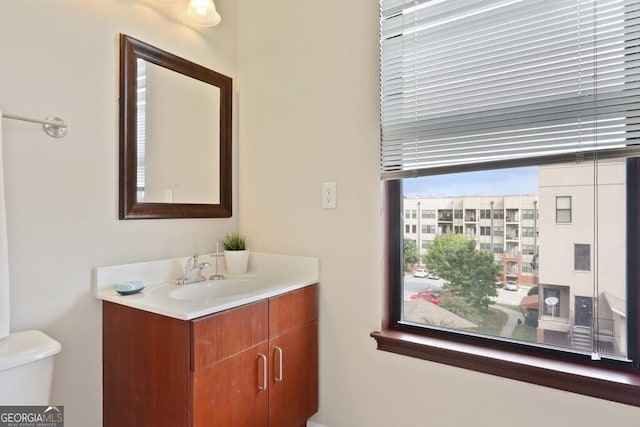 bathroom featuring vanity and toilet