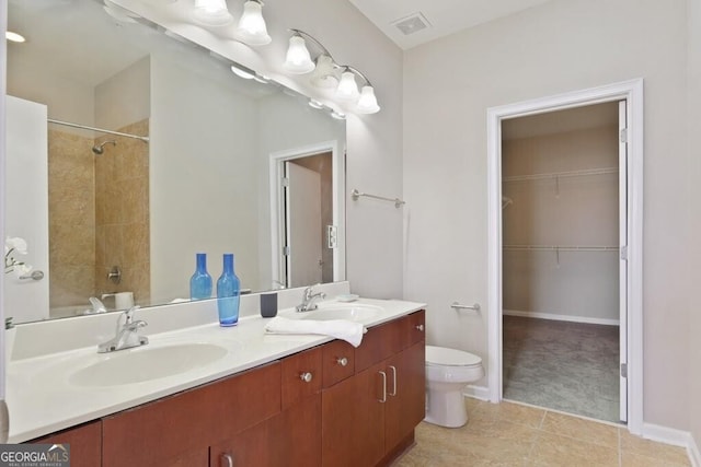 full bathroom with tile patterned flooring, vanity, tiled shower / bath combo, and toilet