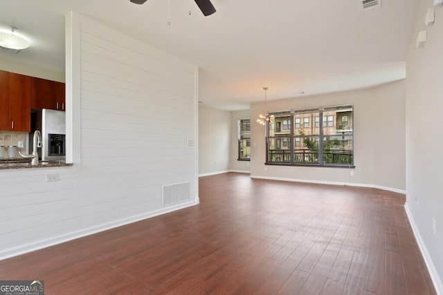 unfurnished living room with sink, dark hardwood / wood-style floors, and ceiling fan