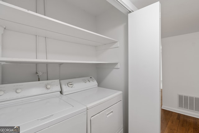 washroom featuring dark hardwood / wood-style floors and independent washer and dryer