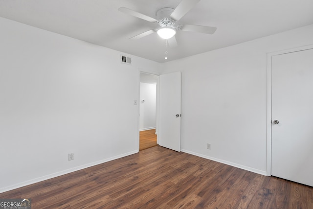 unfurnished bedroom with dark wood-type flooring and ceiling fan