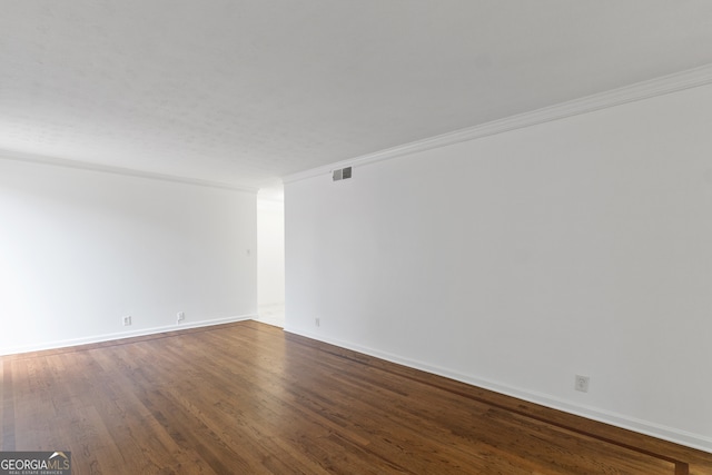 spare room with hardwood / wood-style flooring and ornamental molding