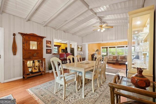 dining area with light hardwood / wood-style flooring, ceiling fan, and vaulted ceiling