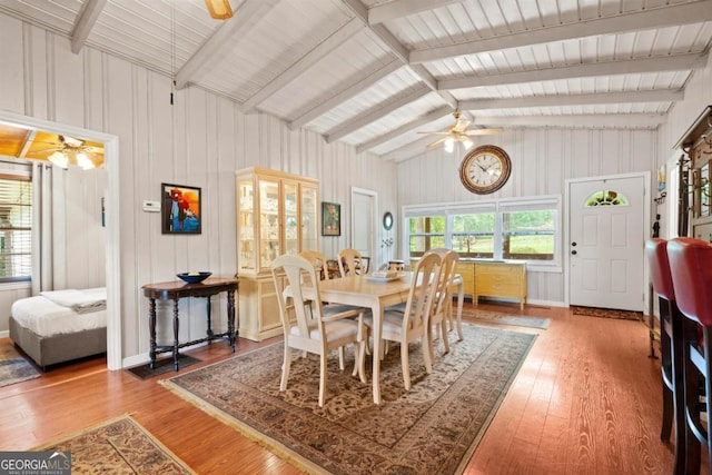 dining area featuring lofted ceiling with beams, hardwood / wood-style floors, and ceiling fan