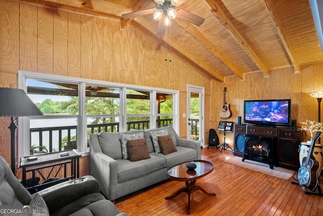 living room with wood ceiling, hardwood / wood-style floors, high vaulted ceiling, beamed ceiling, and wood walls