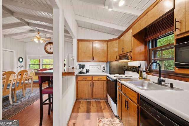 kitchen featuring light hardwood / wood-style flooring, sink, lofted ceiling with beams, and black appliances