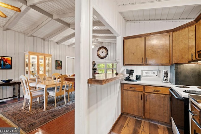 kitchen featuring tasteful backsplash, dark hardwood / wood-style floors, vaulted ceiling, and range with electric stovetop