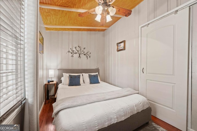 bedroom featuring wood ceiling, dark wood-type flooring, and ceiling fan