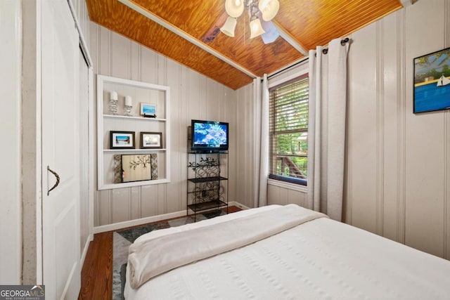 bedroom with dark wood-type flooring, ceiling fan, vaulted ceiling, and wooden ceiling