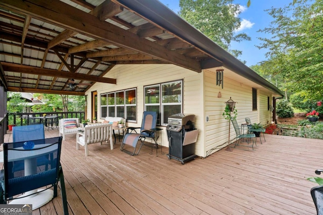 wooden terrace with area for grilling and an outdoor hangout area